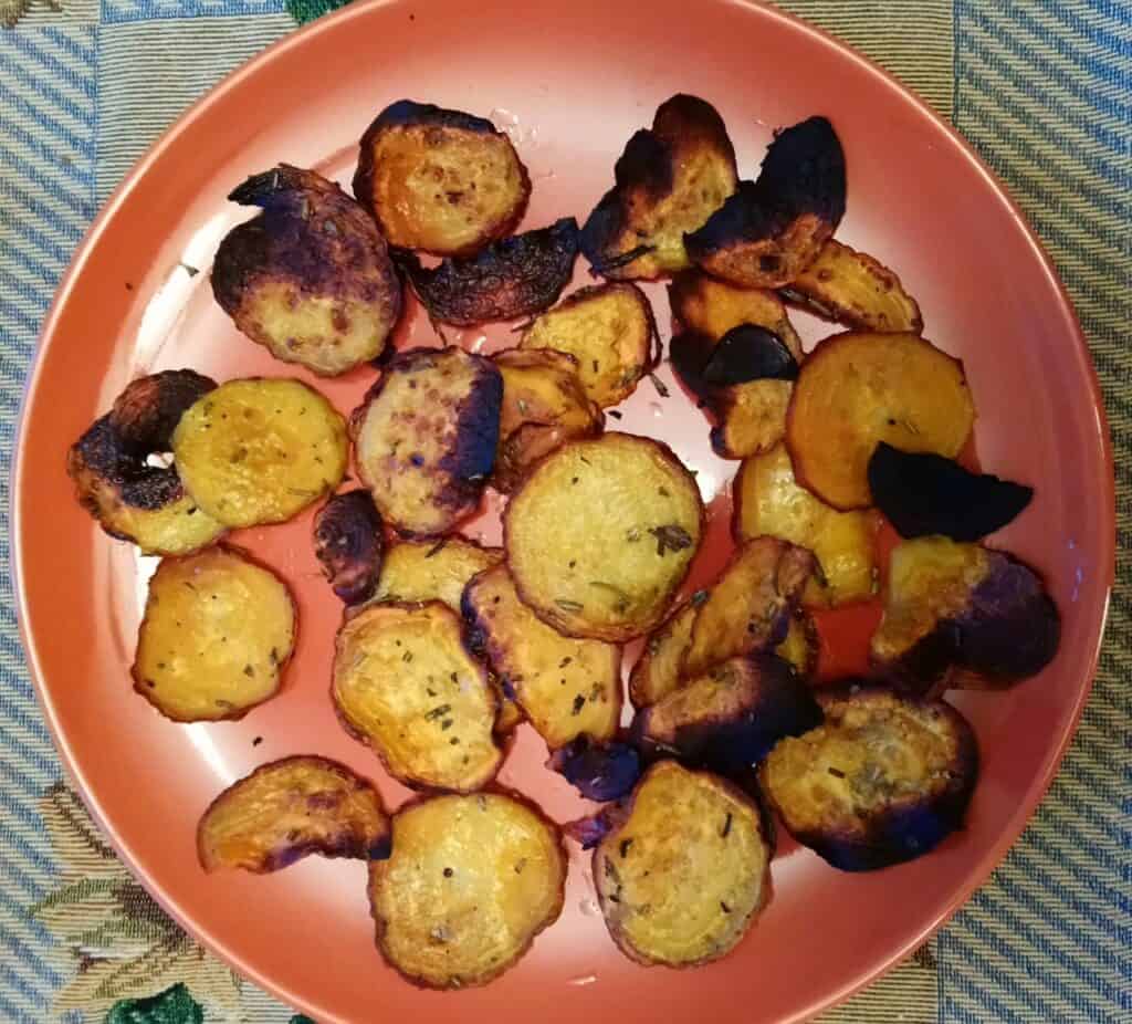 Baked Rosemary Golden Beet Chips on an orange plate