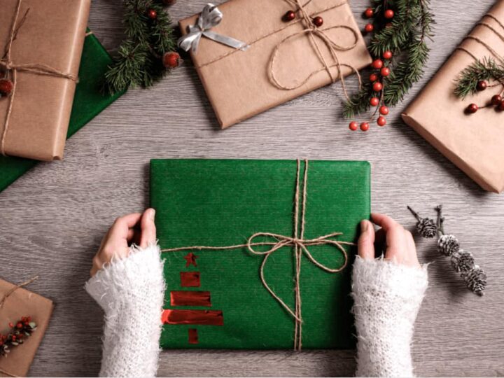 a woman wrapping diy Christmas gifts with homemade wrapping paper