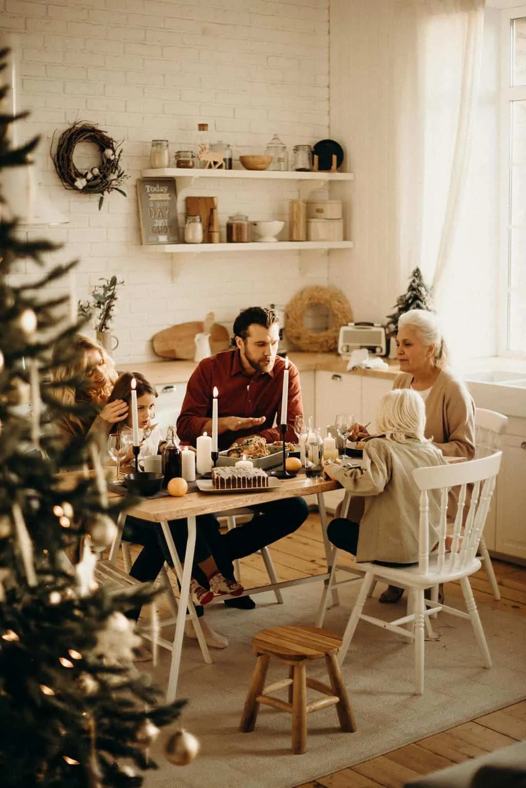 Friends sitting around a table - getting together for a tea party is a perfect advent activity