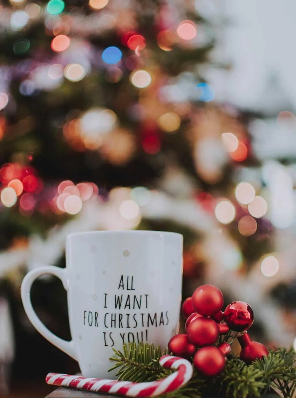 A white mug with black writing in a Christmas scene - a perfect Advent activity