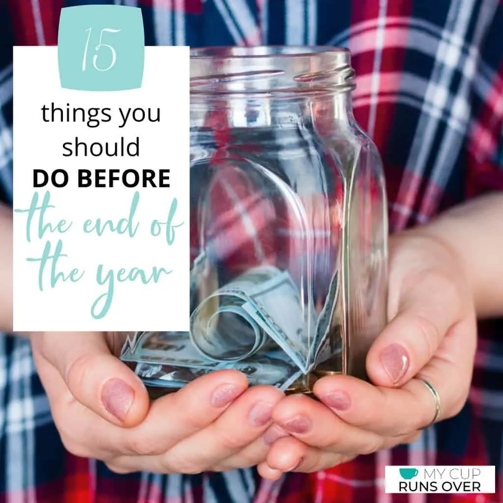 a pair of hands holding a jar of money