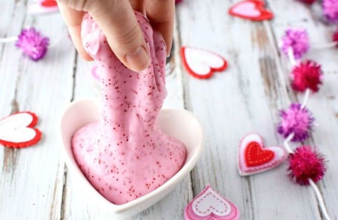 Pink slime in a white heart-shaped bowl