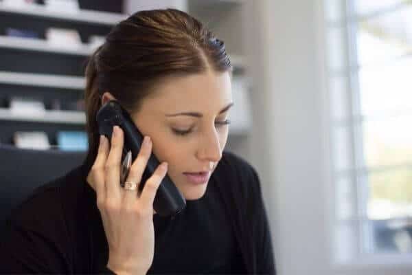 a woman speaks on the phone