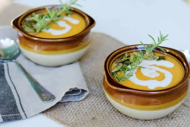 detox recipes - two bowls of curried sweet potato soup on a table