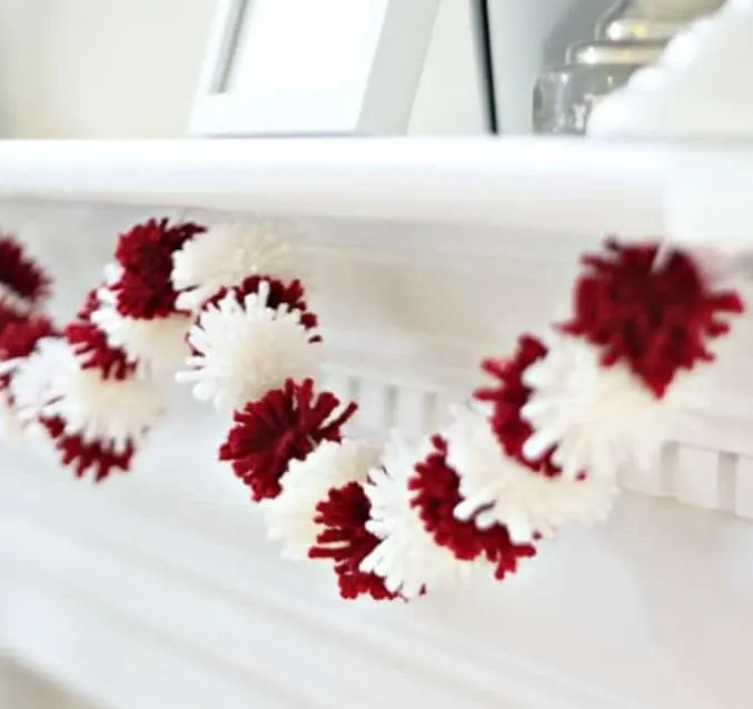 Valentines Day Mini Pom Pom Garland hanging from a white mantle