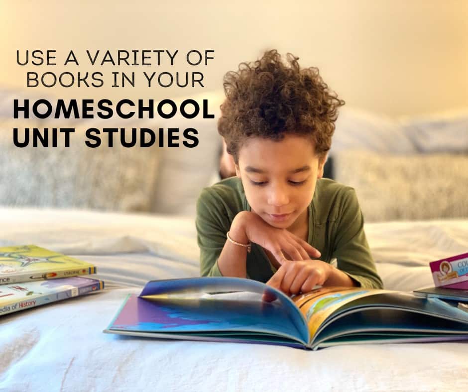 a young girls lies on a bed reading a science book