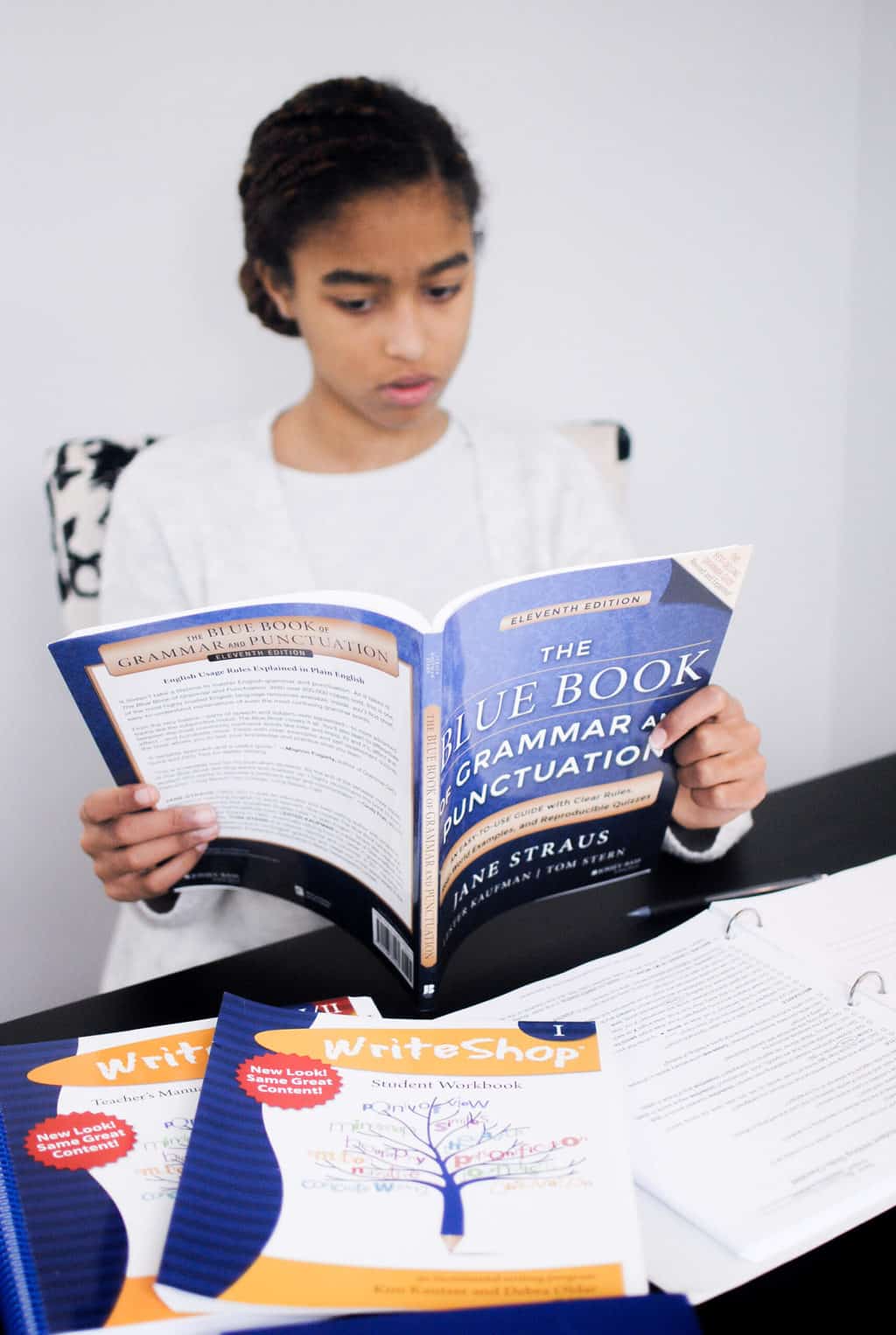 a middle school student studies writing using the WriteShop 1 Starter Bundle. Read through to see how this homeschool writing curriculum compares to Writers in Residence
