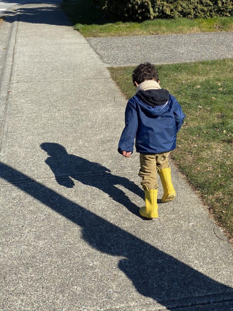 a little boy runs outside - self-isolation doesn't mean we shouldn't be going outside. In fact, playing outdoors and going for walks is one of the best things we can do for our health and sanity right now.