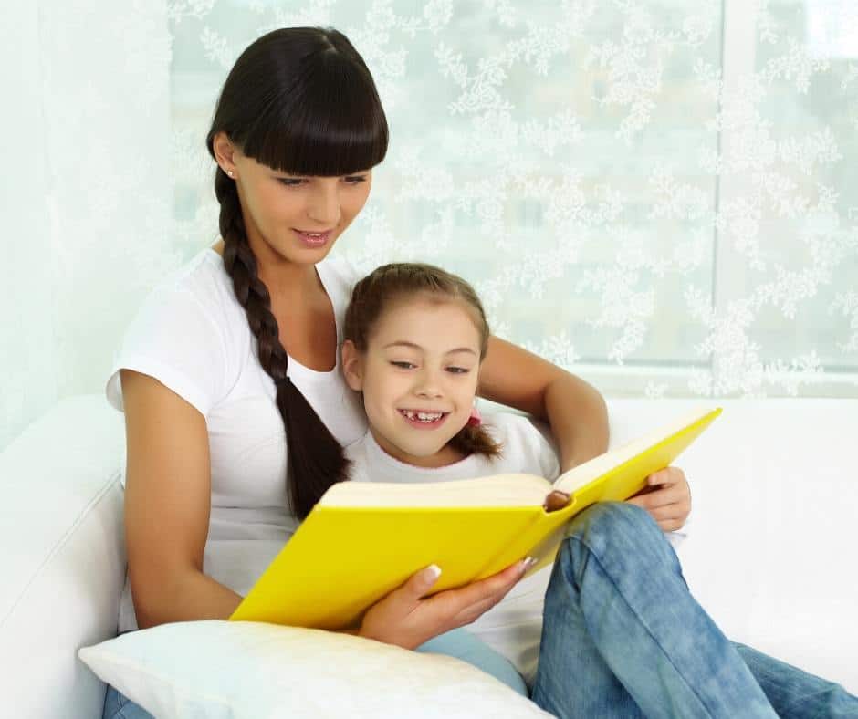 A mom and her daughter read a book together by a window. Reading aloud to your children is a perfect activity to mark the National Day of Unplugging, a day to ditch the devices and reconnect with the world around us. 