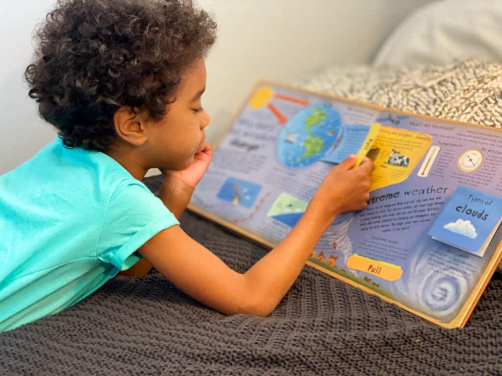 A preschool child reads How the World Words-a top Earth Day book for kid