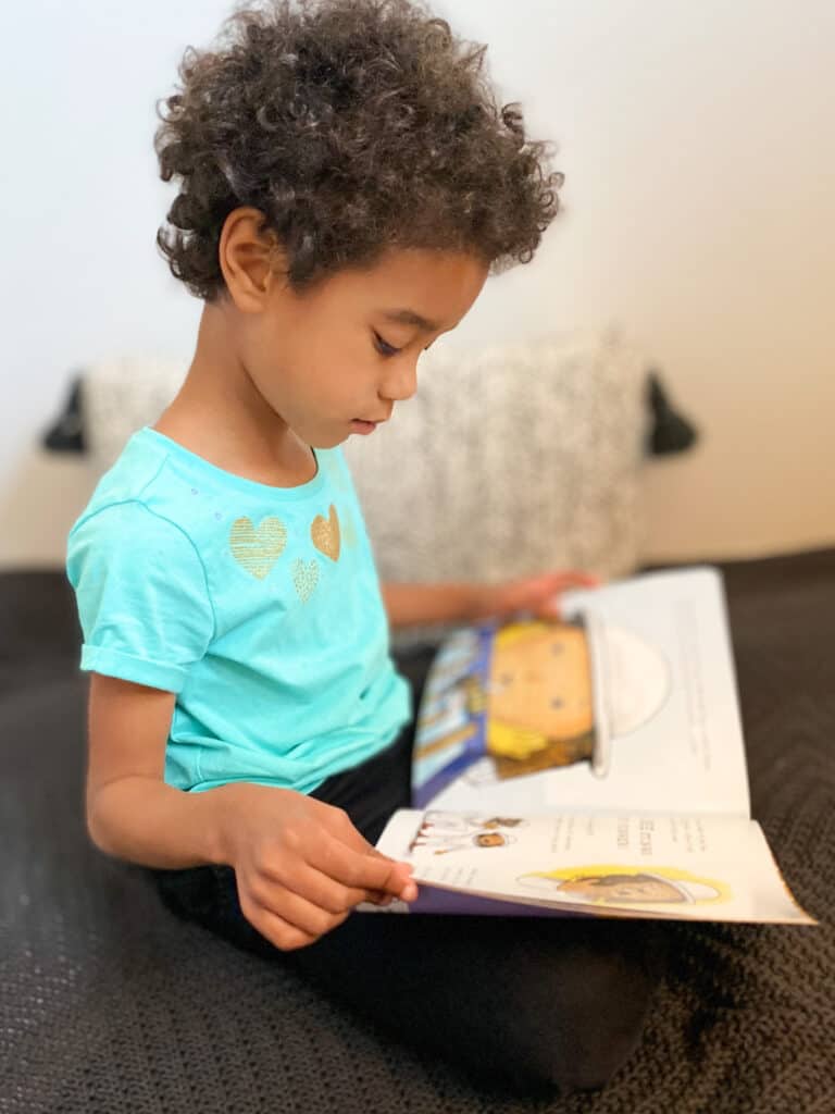 a young child reads Kaia and the Bees-a top Earth Day book for kids