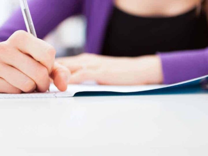 A girl writing - Feature image for 29 Creative Journal Prompts for Teens