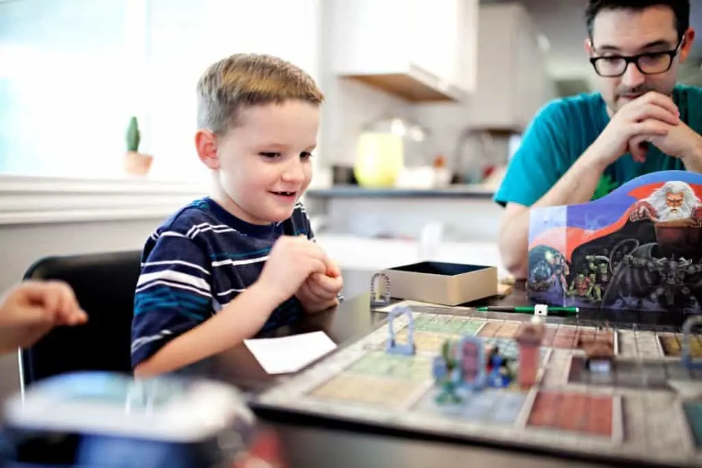 Dad and son playing a board game together for family fun