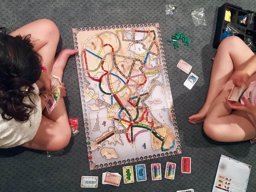 Kids playing Ticket to Ride together as a family