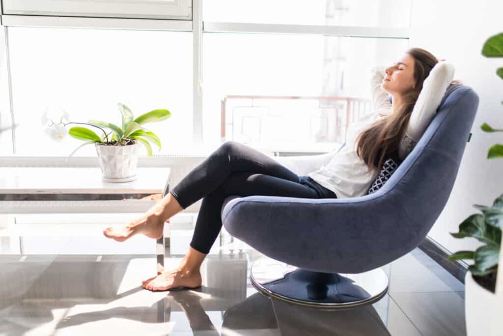 Woman sitting in chair with good lighting in reading nook