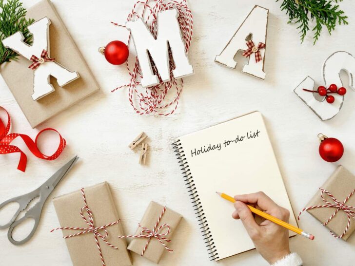a person writes plans for Christmas in a notebook | these tips will help you plan ahead for the Christmas Season