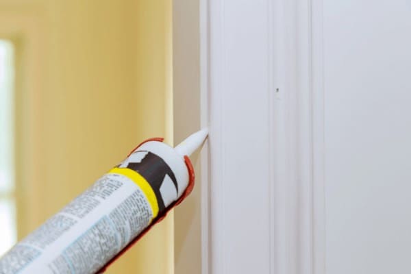 applying caulking or sealant around the doors and windows in your house will help reduce heat loss and help keep your house warmer
