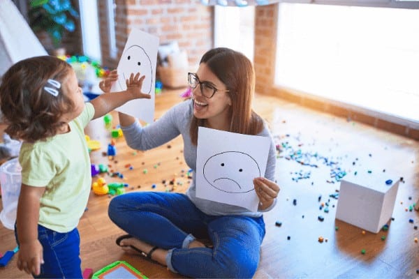 a mother and daughter play on the floor. A relaxed play-based homeschool routine can work great for a kindergarten schedule