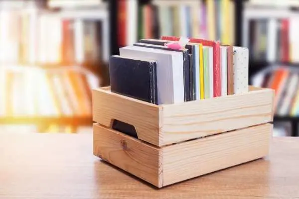a wooden create full of books