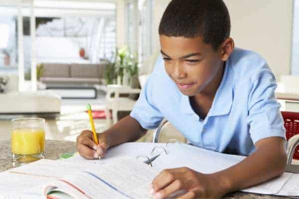 a boy studies in the kitchen