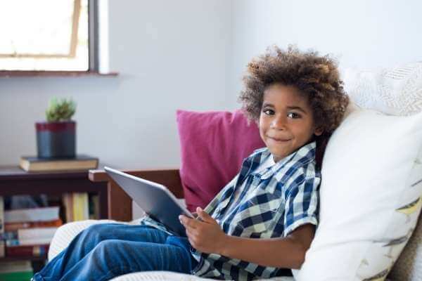 a boy works on a tablet