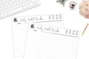 Flat lay image with two free printable habit trackers on a white desktop.