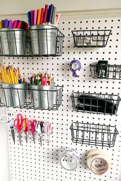pegboard with homeschool supplies - one of my favorite homeschooling room ideas for small spaces
