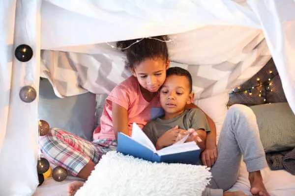 kids read in a fort