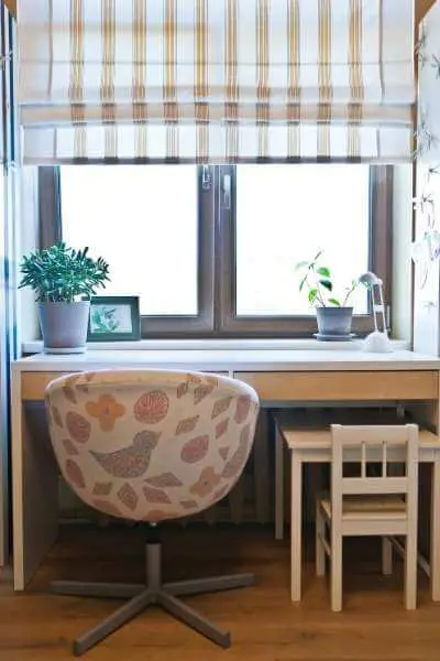 a small desk tucked underneath a big desk - perfect for homeschool storage