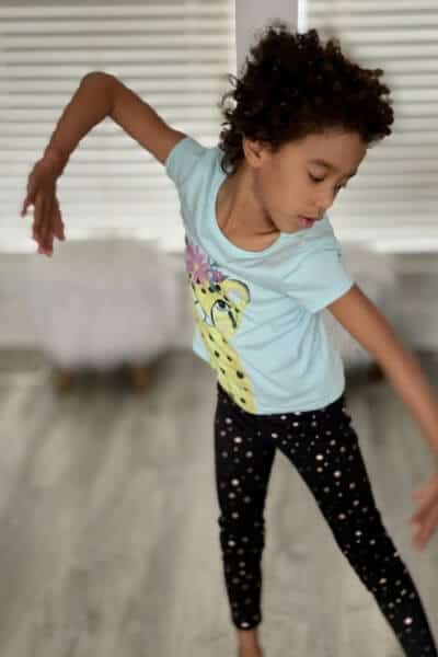 a child dances to classical music: with Clap for Classics! online music classes, kids learn to vocalize and move their bodies to classical music.