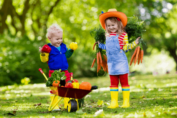 two kids working with garden tools