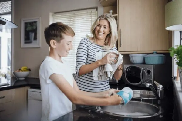 how to connect with your teens - a mom and son wash dishes together