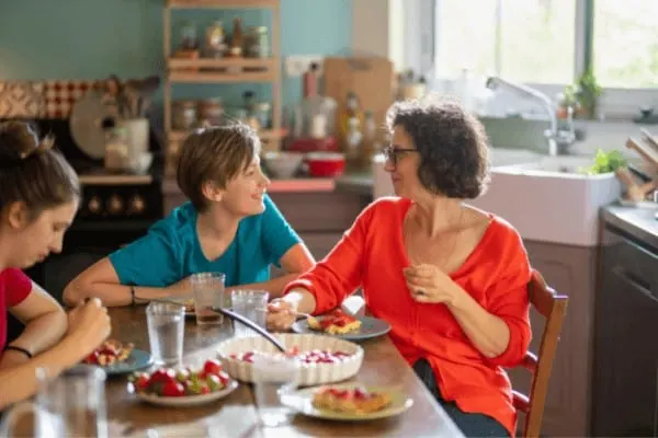 a mother and her teenage children bond with each other over food