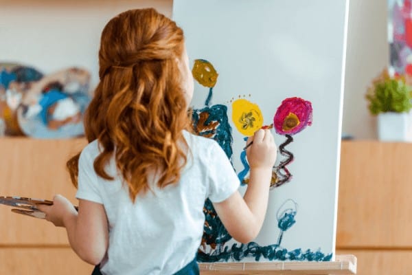 little girl painting a picture