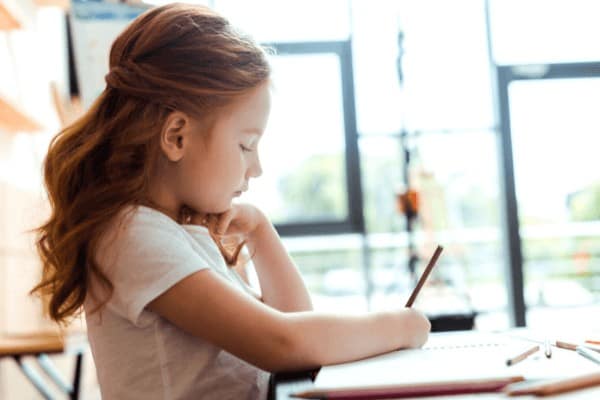 little girl writing