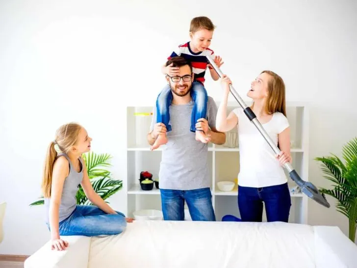 A family cleans together in their living room