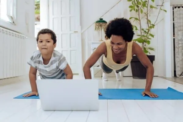 gifts that keep giving | for those who don't have time to make it to the gym, a membership to live online gym classes could be perfect | a mother and her son work out in front of a laptop
