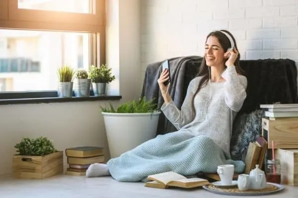 gifts that keep giving | a music streaming service is perfect for those who love music or are searching for something new | a woman listens to music through headphones