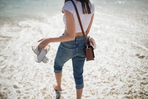 a woman walks along a beach