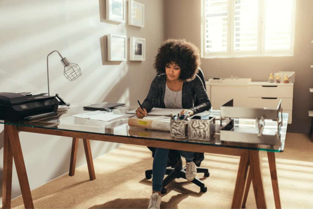 a woman works at a desk