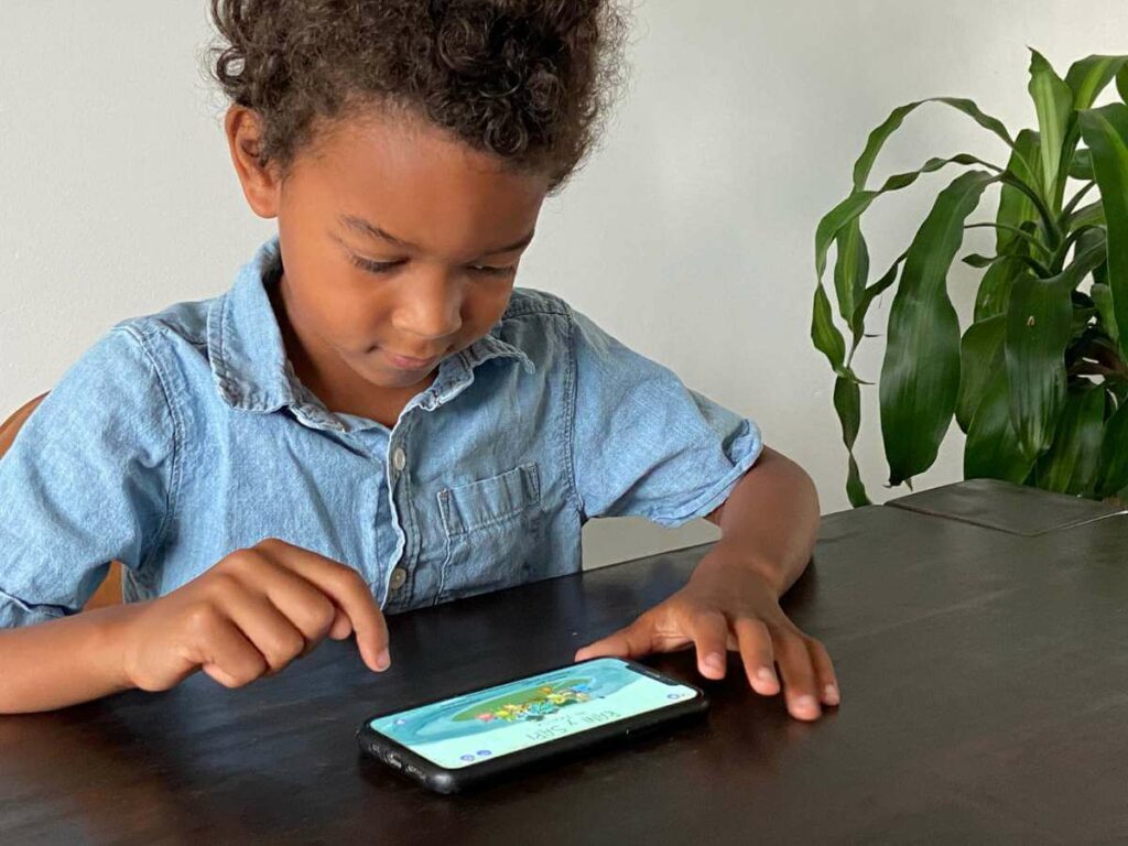 a little boy plays with an online homeschool spanish curriculum