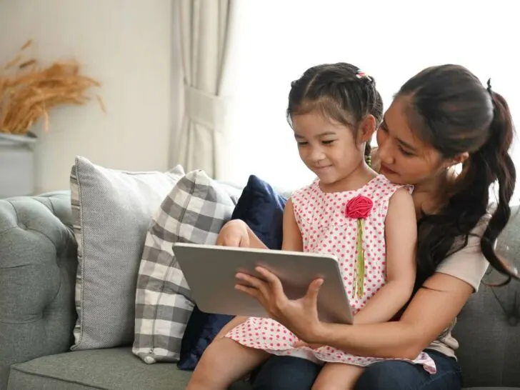 a mom and child use a tablet together