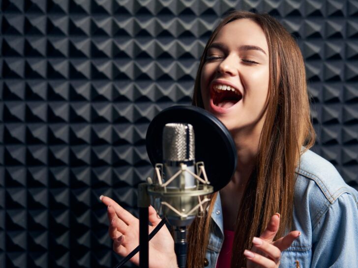 a girl sings into a microphone
