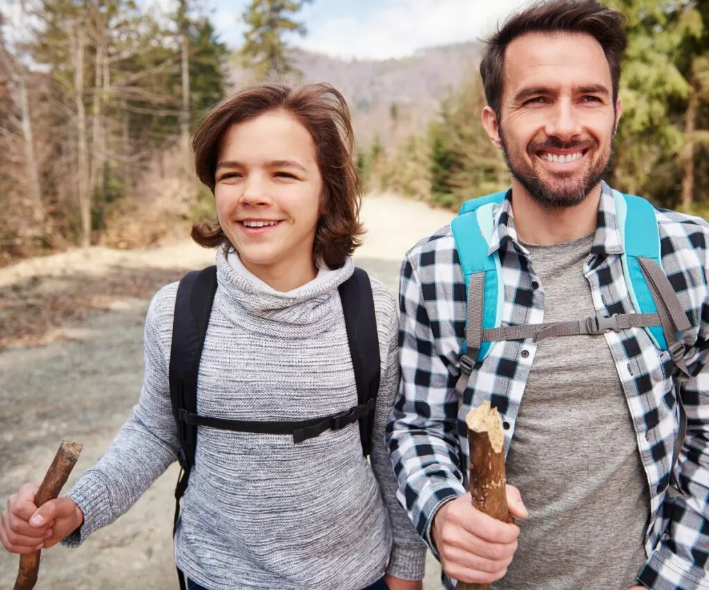 a father and a son take a hiking trip together