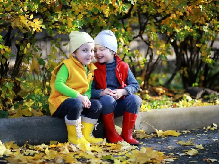 two kids talking outside in the fall