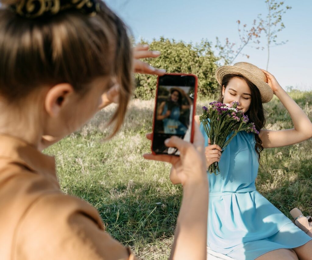 a teen girl gets her picture taken in a field